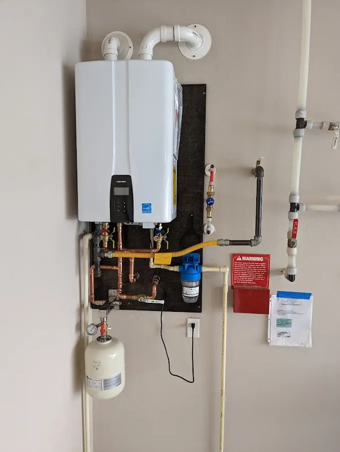 Professional plumber installing copper piping in a Silver Firs home